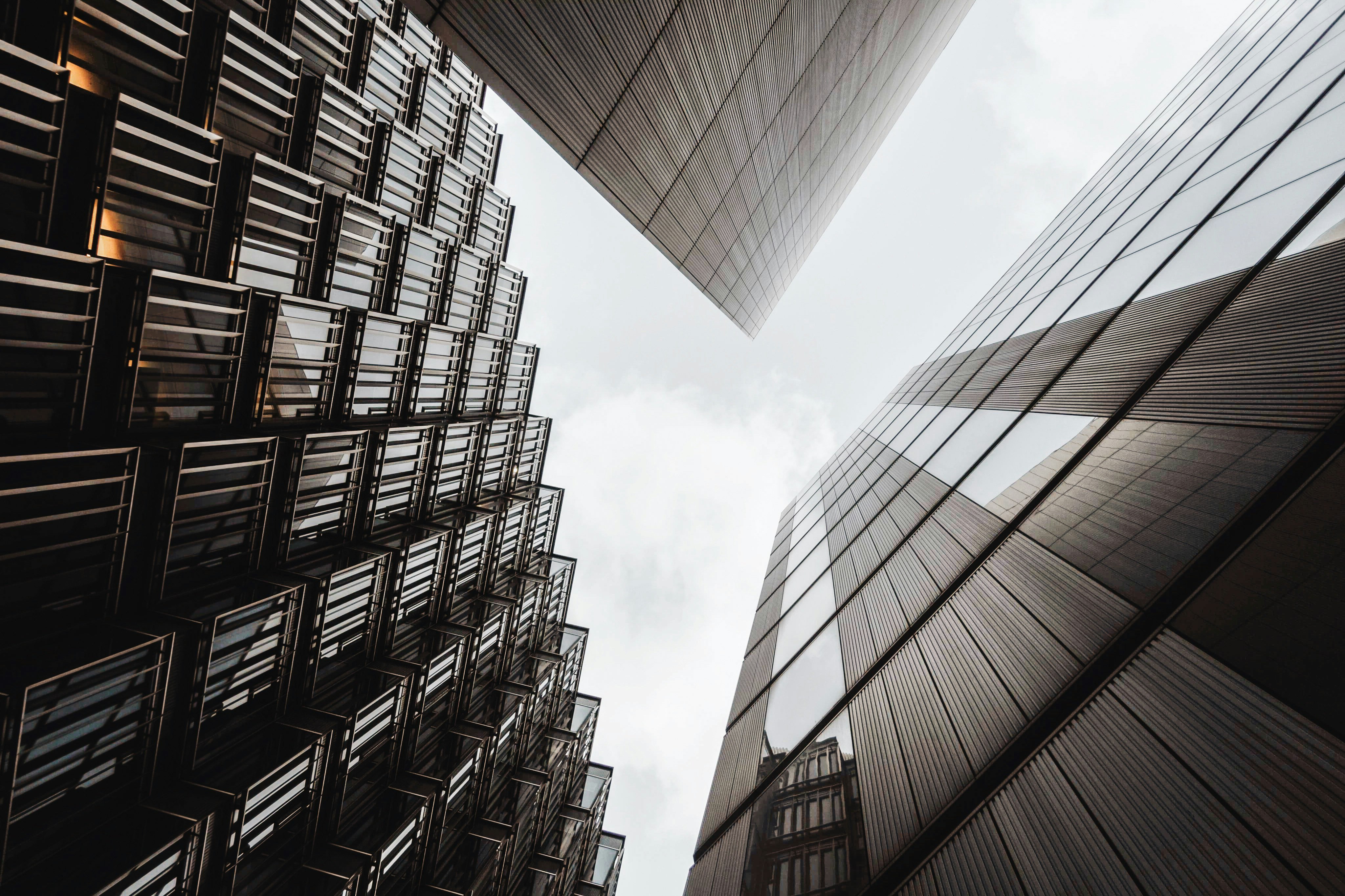 low angle of three gray high rise buildings